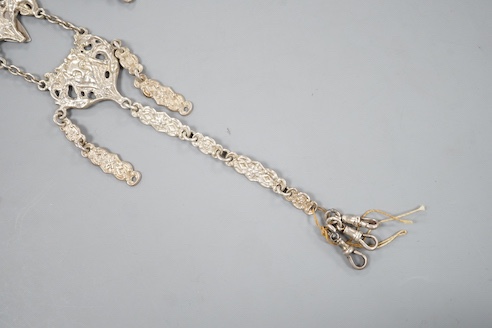 An Edwardian silver chatelaine, pierced and decorated with masks and scrolls, Nathan & Hayes, Chester, 1903, 21.6cm, 78 grams.